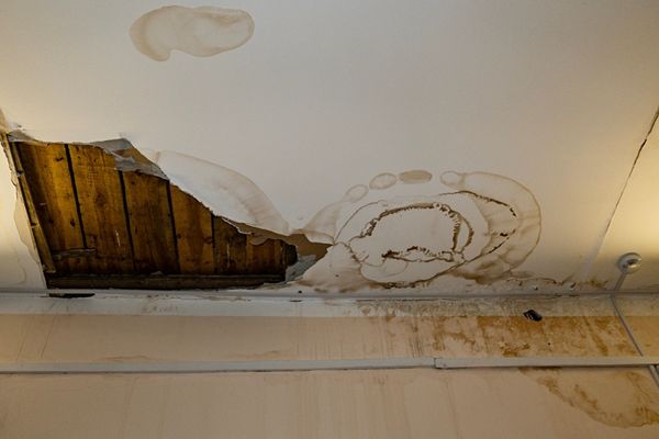 Collapsed ceiling exposing wooden roof